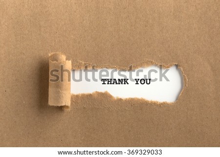 The text THANK YOU behind torn brown paper Royalty-Free Stock Photo #369329033