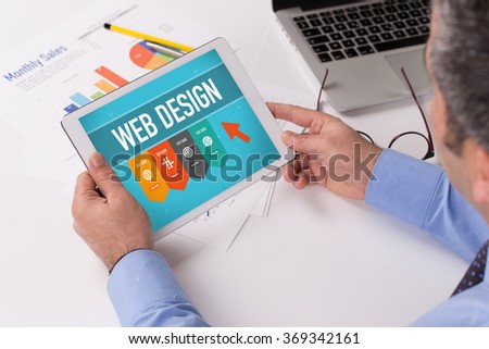 Man working on tablet with WEB DESIGN on a screen