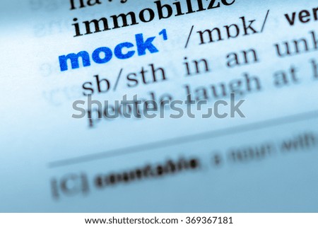 Close-up of word in English dictionary. Mock, definition and transcription