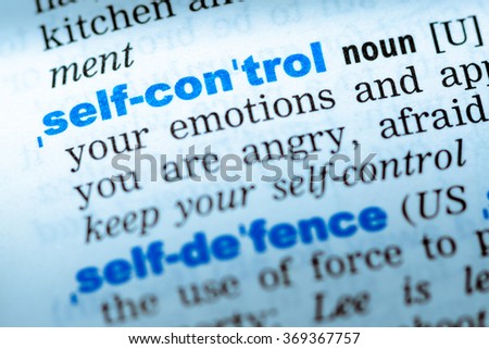 Close-up of word in English dictionary. Self control, definition and transcription