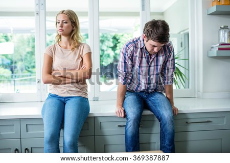 Annoyed couple ignoring each other in the kitchen