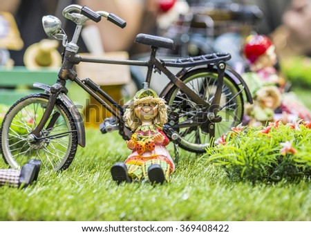 Ceramic doll and bicycle doll with blurred background