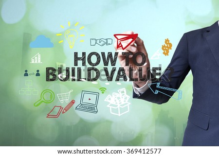 Businessman writing and drawing DATA ANALYSTS concept on blurred abstract background , business concept , business idea