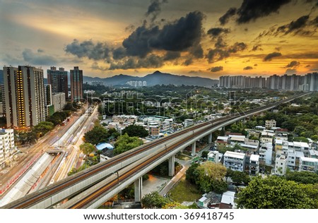 hong kong cityspace and speed train at sunset