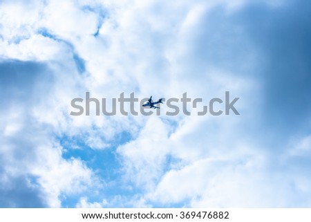 airplane flies on a blue sky Royalty-Free Stock Photo #369476882