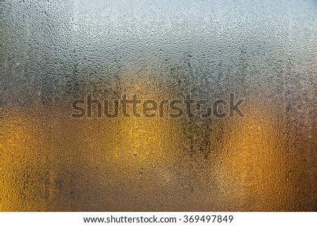 background of wet glass drops autumn yellow and blue sky 