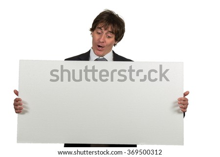 Happy smiling business man showing blank signboard, isolated over white background.