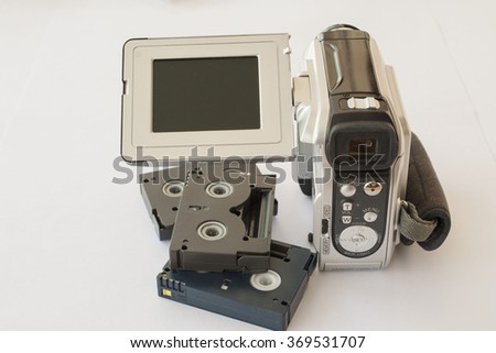 video camera with mini cassette on white background