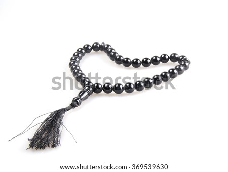 Black prayer beads in the shape of a heart (isolated on white) Royalty-Free Stock Photo #369539630
