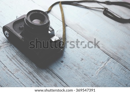 camera on blue  wooden table