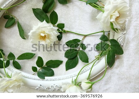 The beautiful and luxury of white roses and vintage frames on background of velvet