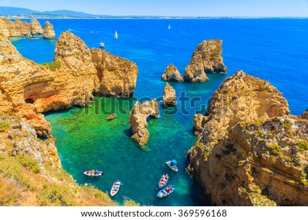 Fishing boats on turquoise sea water at Ponta da Piedade, Algarve region, Portugal Royalty-Free Stock Photo #369596168