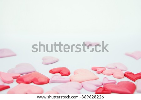 Valentines day wallpaper.Light pink and red love hearts on white paper background.