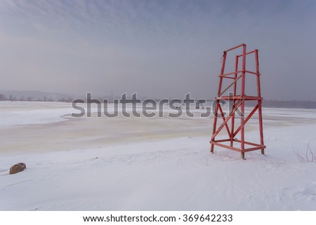 Winter landscape. Dniepr river bank in Kiev. Ukraine. Frozen river. Lifeguard tower on the winter snowy beach. Kiev. Ukraine.
