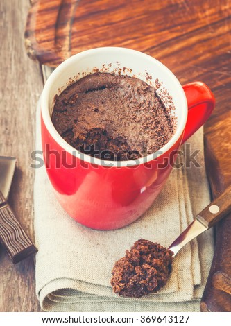Chocolate cake in a mug. Vintage toned picture.