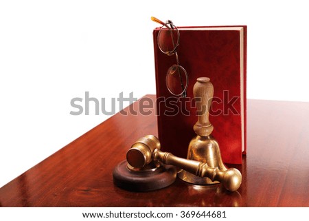 Gavel made of bronze, the book and glasses on a table