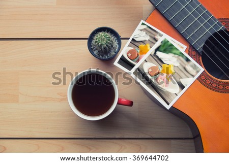 Memories of music travel stuff and coffee with macaron in photo pic on wooden table,vintage tone in photo.