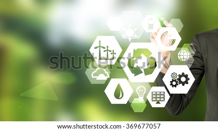 hand drawing signs of different green sources of energy in hexahedron shape, a 'reduce, reuse, recycle' sign in the centre. Blurred green background. Concept of clean environment.