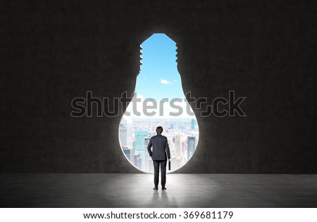 businessman with a case in hand standing in front of a huge keyhole of the bulb shape ready to make a step forward. New York seen in the hole. Back view. Concept of opening new horizons.