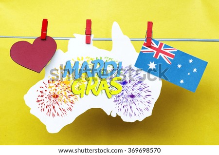 Australian maps (red heart) and flag hanging pegs on yellow, Mardi Gras.  rainbow flag