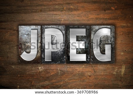 The word "Jpeg" written in vintage metal letterpress type on an aged wooden background.