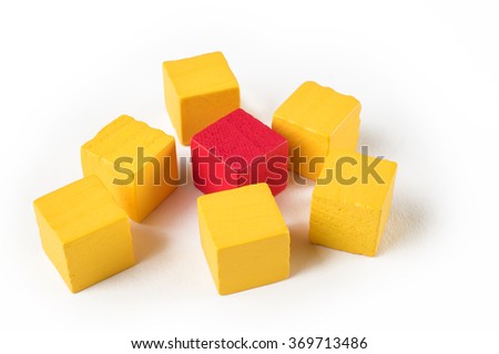 One red wooden mini block among yellow blocks symbolizing exclusion, difference, or bullying
