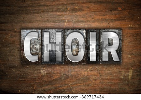 The word "Choir" written in vintage metal letterpress type on an aged wooden background.