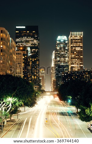 Los Angeles downtown at night with urban buildings and light trail