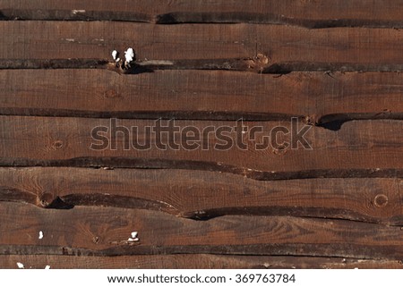 Crude wooden fence with snow. Seasonal background.