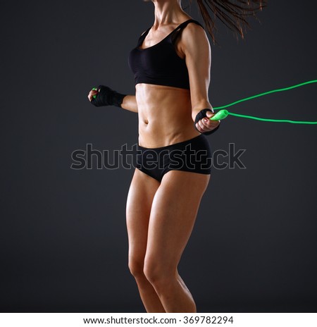Full length view of an attractive woman with jumping rope Royalty-Free Stock Photo #369782294