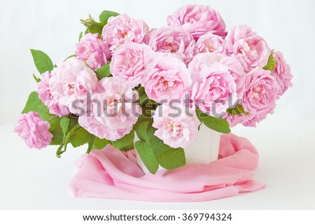 Pink roses bunch in vase on artistic background. Still life with pink roses bunch