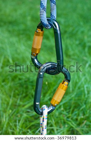 two carabiners on a green grass background