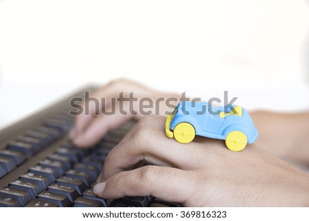 car model on back hand typing keyboard 
