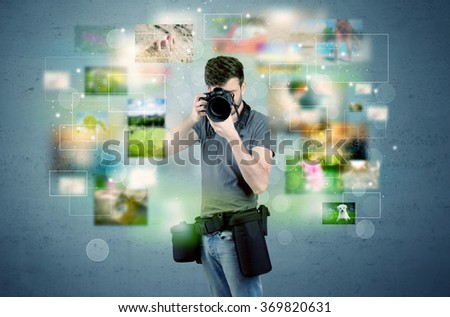 A young amateur photographer with professional camera equipment taking picture in front of blue wall full of faded pictures and glowing lights concept