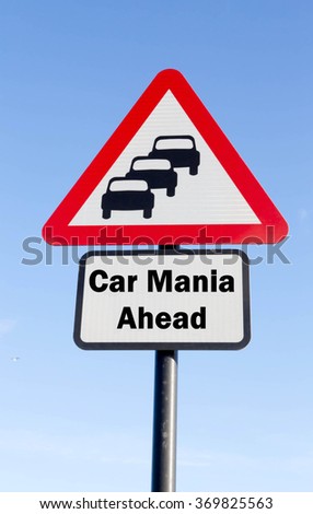 Red and white triangular road sign with a Car Mania Ahead concept against a partly cloudy sky background