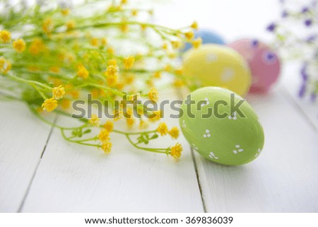 Colorful decorated easter eggs on white wood background. Happy Easter.