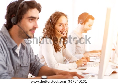 View of a Young attractive man working in a call center Royalty-Free Stock Photo #369840131