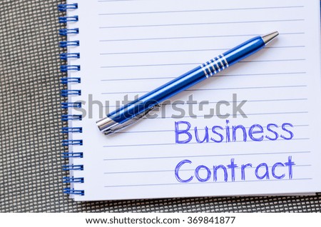 Business contract text concept write on notebook with pen
