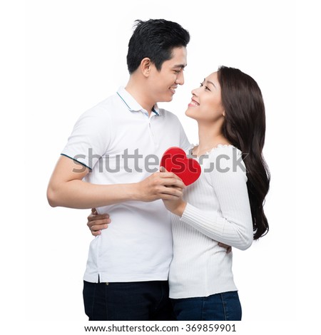 picture of family couple in a sweaters with heart. Beautiful young love couple embracing against a white background