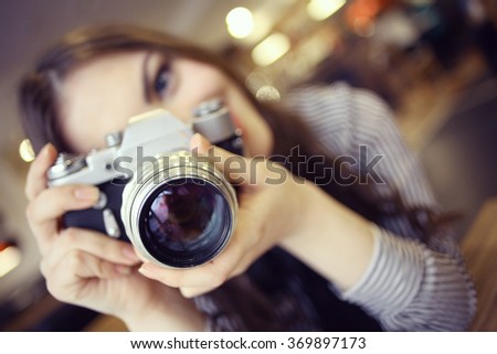 young girl with a vintage camera