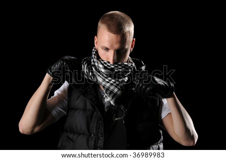Hip hop dancer with scarf isolated over black background