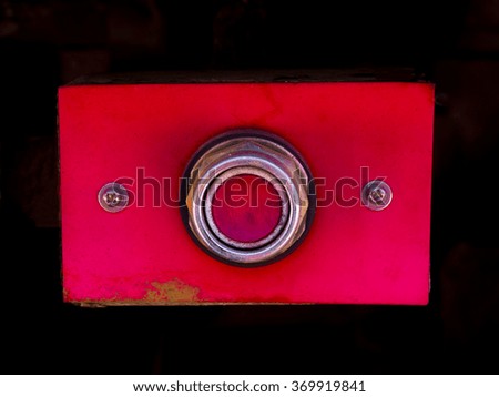 A red button in a chrome case.