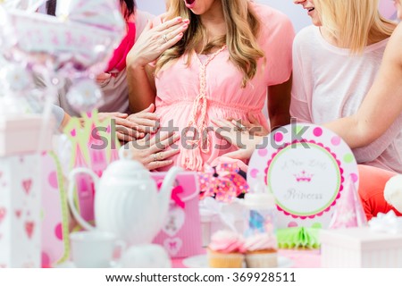Best Friends on baby shower party celebrating giving kid stuff as present Royalty-Free Stock Photo #369928511