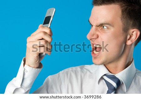 Angry businessman screaming on the mobile phone. Find more similar pictures in my portfolio