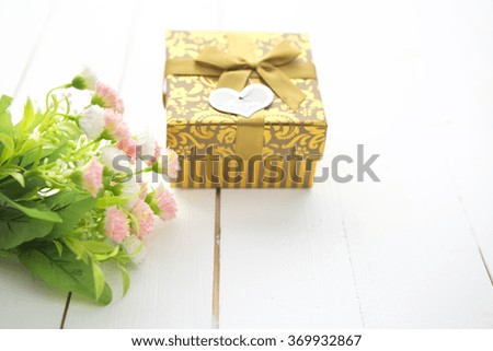 Gift box with heart and roses on wooden table for Saint Valentines day