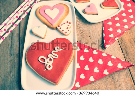 Heart shaped cookies made by hand on old wooden table.