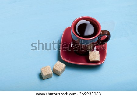 Coffee in cup on blue wooden table.