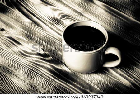 Coffee in cup on wooden table for background. Toned.
