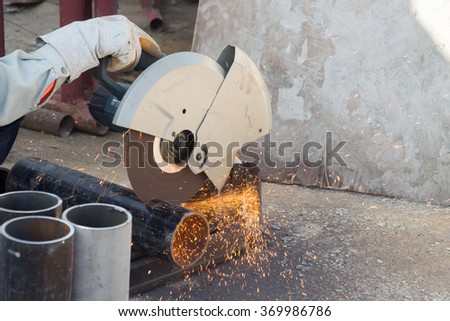 closeup on electric saw and hands of worker with sparks. man working with grinder, close up on tool, sparks fly, real situation picture