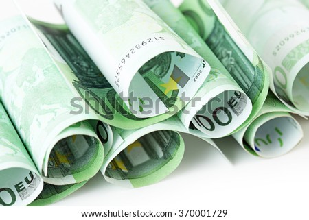 100 euro banknotes rolled up on white background